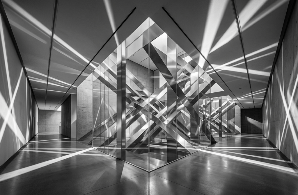 A minimalist black and white architectural photograph representing precision digital routing and segmented communication channels for advisory firms.